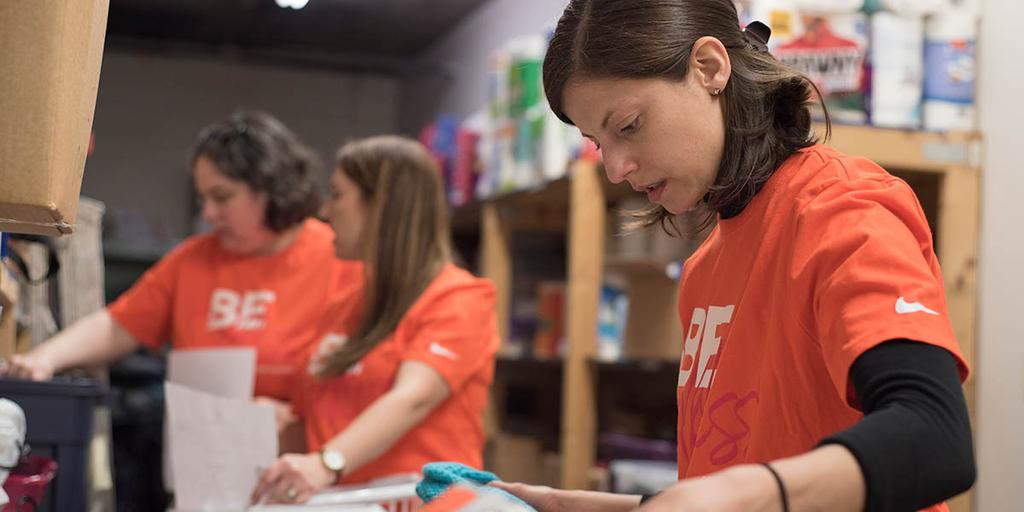 A group of CoverMyMeds employees in a candid photo volunteering.